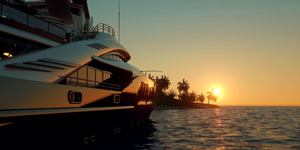 Yacht de luxe écologique naviguant au coucher du soleil, incarnant une nouvelle génération de navigation durable et silencieuse sur les mers tropicales.